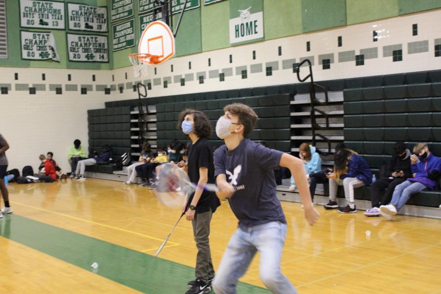 Junior Jack Melton swings at a birdie during PE class. PE provides a break from standard classes for students. However, the Board of Education is possibly removing half of the PE credit.