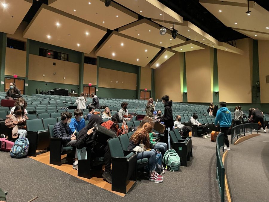 Symphonic Orchestra students prepare for a rehearsal in the auditorium for their upcoming winter concert. Practice in the auditorium is especially useful this year as many students have not had experience playing live there.