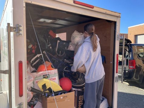 The vice president of LPF, Sydney Stein fills the truck with the donated sports equipment from this years holiday drive. After just two days of donations, the club collected a wide variety of sports goods to fill the trailer up to the top.