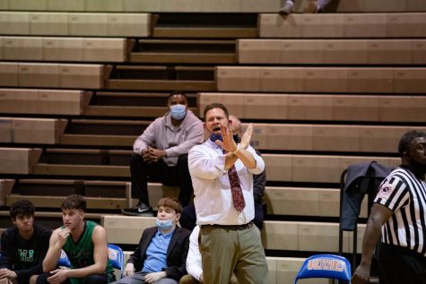 Kevin Parrish coaches the boys varsity basketball team from the sidelines. Along with coaching, Parrish also teaches math at WJ during the day.
