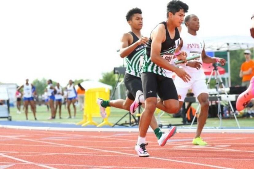 Junior Quentin Williams and senior Fernando Ibarra sprint past the competition in the relay event. After a very strong spring season the WJ track team looks to carry their success into the indoor season.