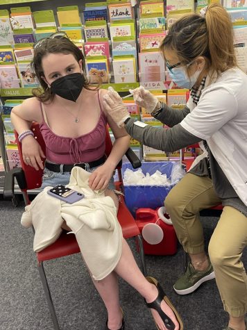 Senior Maeve Sanford-Kelly receives her COVID vaccine when she became eligible in the late spring of 2021. As the booster vaccine has become available to more of the population, Kelly awaits her opportunity to get the final dose.
