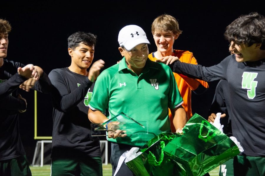 Head+Coach+Hector+Morales+receives+an+award+for+all+he+has+contributed+to+the+Walter+Johnson+soccer+program.+Seniors+%28from+left%29+Mathew+Eisenbrey%2C+Fernando+Ibarra%2C+Leo+Dobosz%2C+and+Alejandro+Linares+surround+him.