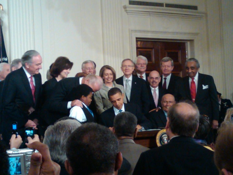 Former president Barack Obama signs the Affordable Care Act into law in 2010. This law expanded healthcare to over 25 million more people but failed to provide universal coverage.