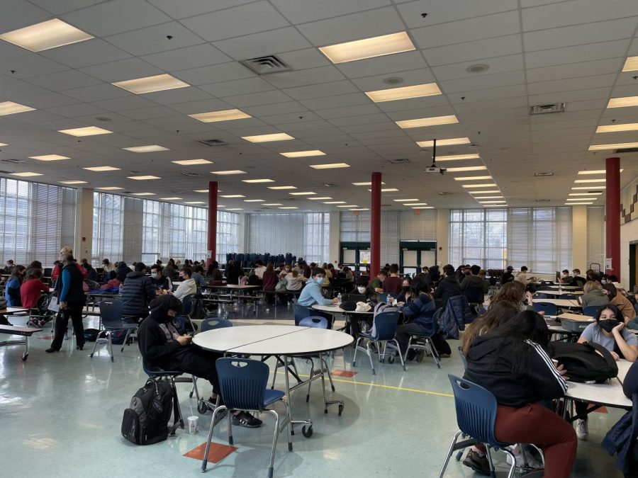 Students sit in the cafeteria during a study hall. Students are often sent to the cafeteria if their teacher is out with Covid because there are not enough substitutes to cover all the classes.