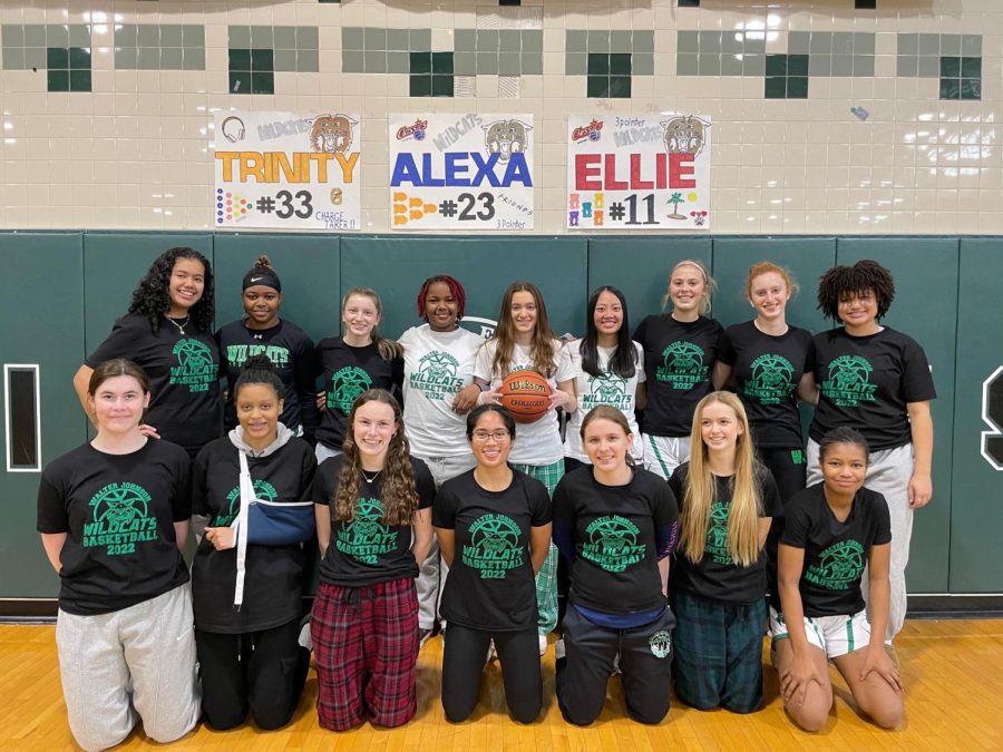 The varsity girls basketball team take a team photo before the last home game on senior night. Seniors Trinity Hill, Alexa Hackman and Ellie Tan were worried they wouldnt have a senior night when their season was paused due to covid.