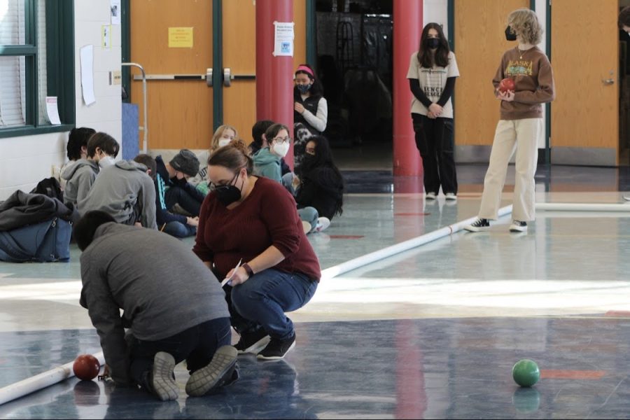 Coach Emilia OConnor and senior team manager Jomel Velasquez examine a well thrown ball during practice.