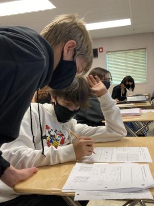 Freshmen Jasper Goldstein and Dylan Oliver work closely together on classwork for Algebra 2. Since students have returned to classrooms, everyone in school has been required to wear masks; however, this mandate may soon be lifted.