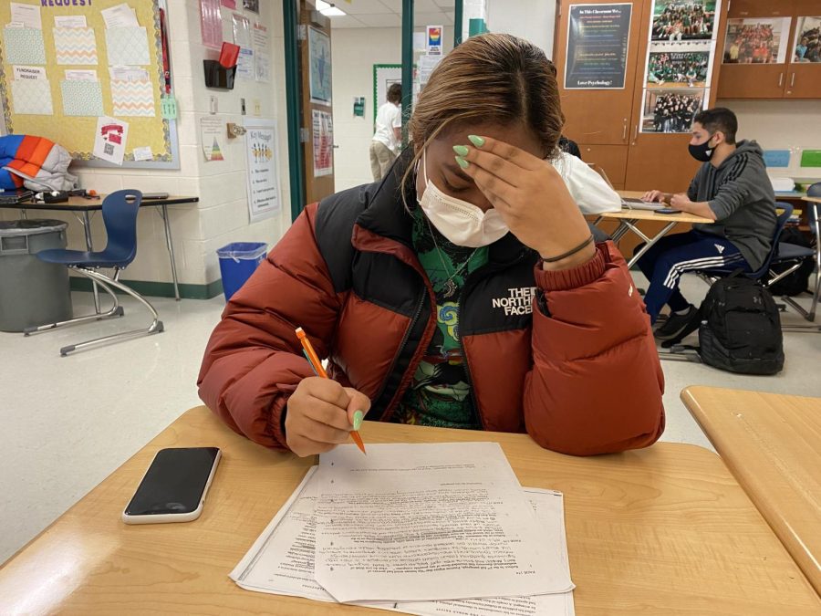 Senior Saige Pasard works on homework during free time in a class. As students continue on into the second semester the workload is becoming a lot to manage.