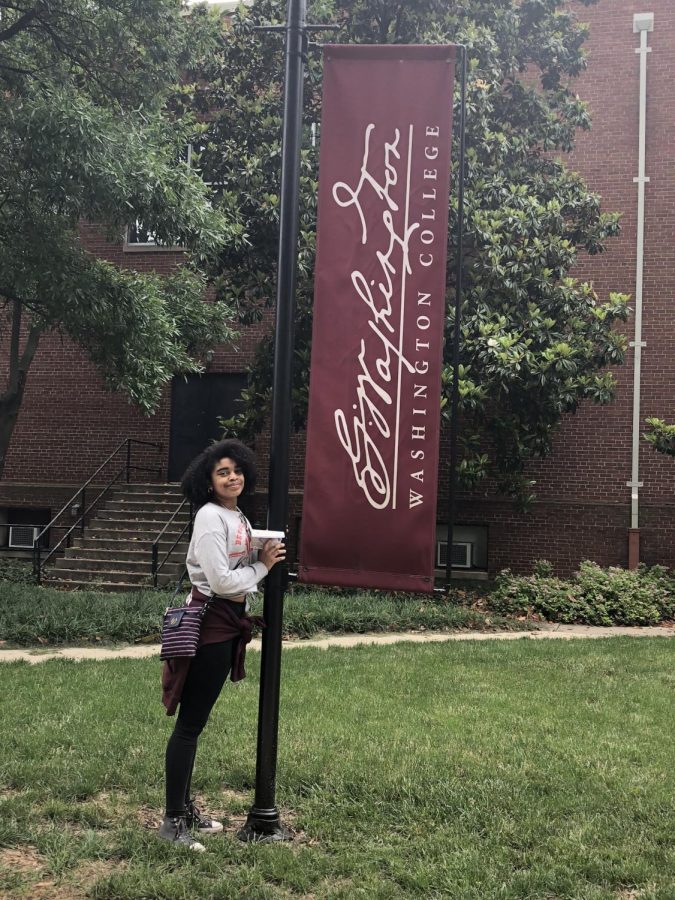 Senior Kyaran Brooks poses in front of Washington College banner. “I’m going to a liberal arts college. Being able to combine different majors and not having to stick to one path is something that I really like because I have different interests and I want to study different things is definitely a major factor, Brooks said.