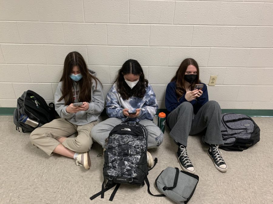 Freshmen (from left) Sofia Reyes, Alexa Buss and Arielle Boxt play Wordle during lunch. I try to use a different word everyday in hopes that one day it will be the word and I can guess the word in one try, Buss said.