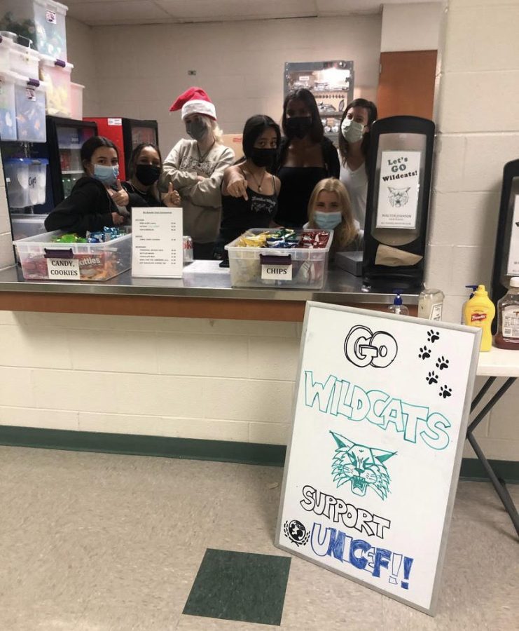 From right to left: Julia Ratner, Julianna Taj, Eva Griebel, Fiona Galang, Sage Crittenden, Lucy  Piemme, and Laura Brager work the concessions stand to support the Unicef club. The profit they earned that night went to the Unicef global organization.