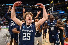 Number 25 Doug Edert and the Peacocks celebrate the win after the insane upset against Kentucky.