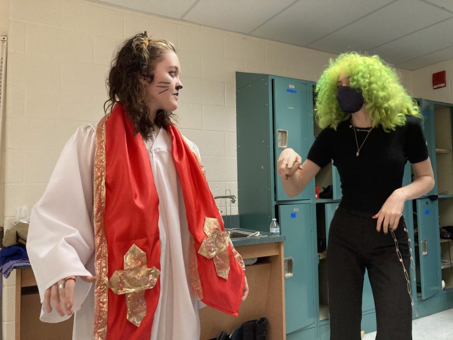 Freshman Aurelia Withers and sophomore Rey Gutierrez-Micallef discuss one of Withers costume change. With a smaller number of cast members, some have to play multiple roles at once.