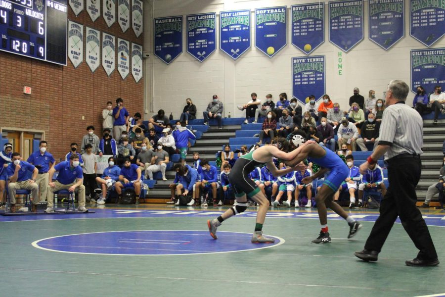 Grady Hutton fighting for the inside tie with his opponent from Churchill. The referee closely watched for any rule breaks as the two try to pin one another.