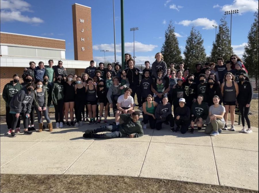 WJ Crew poses in front of the school, proud of the community they represent. As cases drop in MCPS, they hope that their membership will return to its former glory.