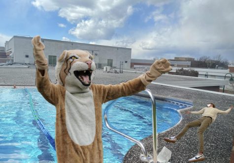 The Wildcat mascot waves away spectators as they cluster around senior Hunter Hicks. Hicks had been pulled from the water by the Wildcat moments earlier, following his near-drowning.