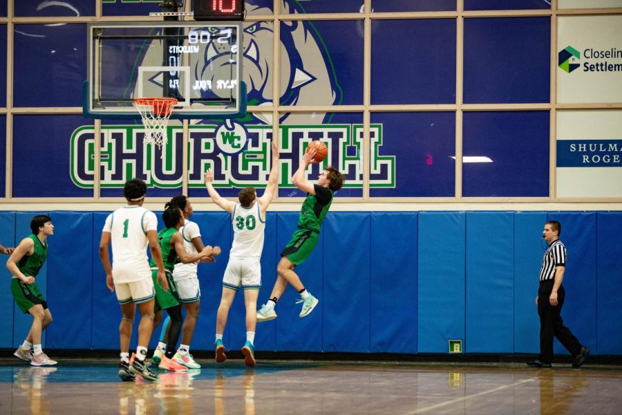 Senior Jack McGuire goes up for a contested fadeaway jump shot against Churchill in the 2nd round of the playoffs. WJ lost the game 68-55, but McGuire finished with a team-high 16 points.