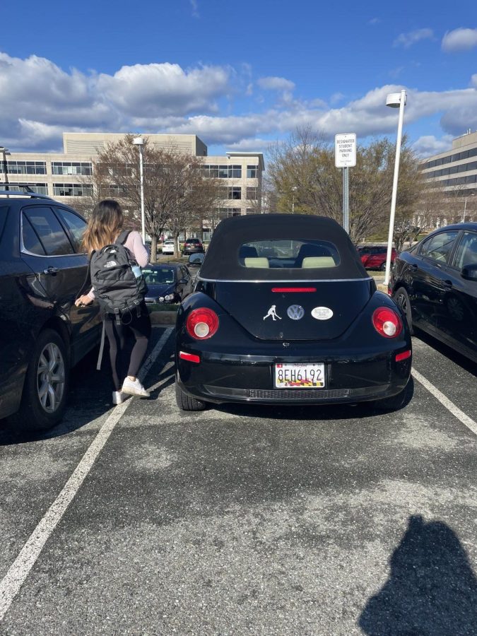 Junior Julianna Taj walks to her car, which is parked in the senior parking lot, although she is not permitted to.