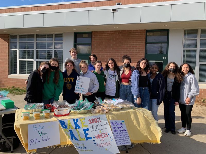 Students+from+various+WJ+clubs+pose+for+a+photo+during+a+bake+sale+to+raise+funds+for+Voices+of+Children.+The+bake+sale+raised+over+%241%2C000.