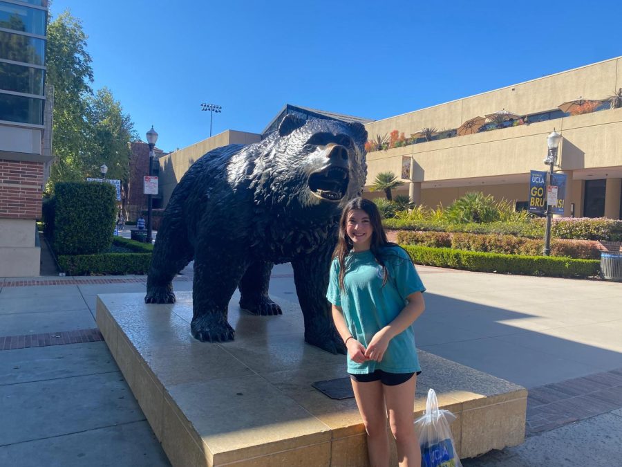 Junior Kate Fuller stands with UCLAs bruin mascot during a tour of the school. Fuller had never been to California yet was interested in schools there. By touring schools such as UCLA she was able to decide if she could see herself in California.
