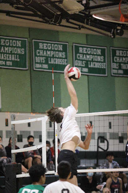 Junior and team captain Sebastiano Sani spikes the ball during the teams home game against Wootton HS, April 4th. The team ended up beating Wootton 3-1 to continue its winning streak.