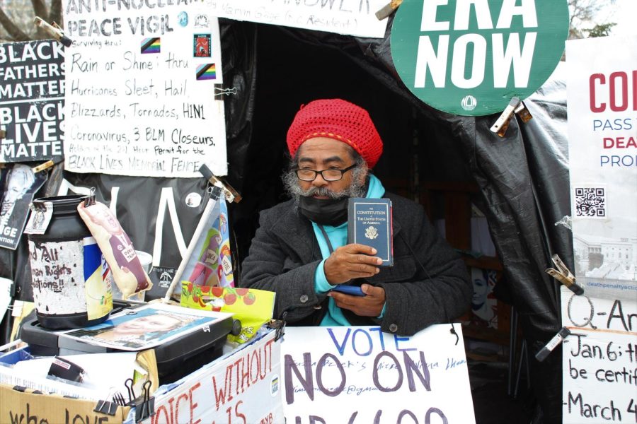 Philipos Melaku-Bello has been sitting in front of the White House for over 30 years promoting messages of anti-war and human rights. He said he had to face over 35 law suits, but the small book he held in his hand, a copy of the US Constitution, has saved him every time.