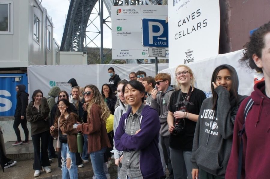 Students laugh beneath The Dom Luís I Bridge entrance in Porto. On this rainy day they watched chaperone Kim Rief slip in the rain several times.