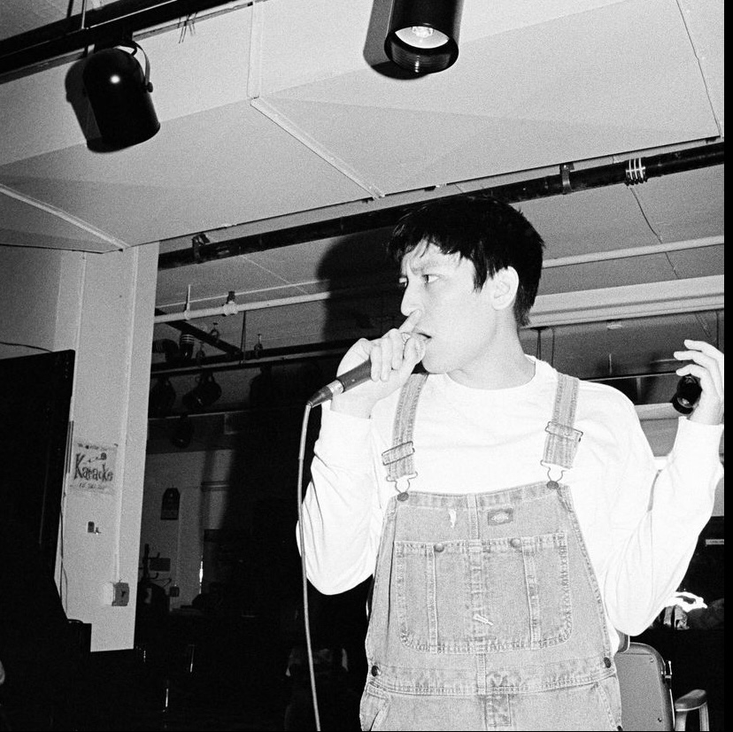 Artist Jacob Daley performs a set with an enthusiastic crowd at Astor Place, an East Village barbershop.