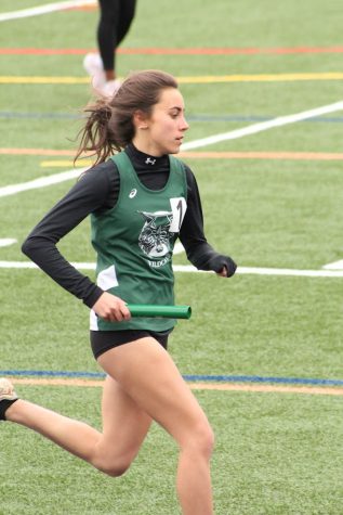 Senior Emma Kothari races to the finish line during her 4x400meter relay at the Screaming Eagle Invitational. Kothari and her relay members finished in first place.