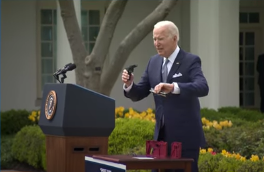 President Joe Biden shows an example of a DIY ghost gun that can be easily assembled. Biden announced new rules on ghost guns at a White House press event on April 11.