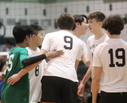 The team celebrates a point during their April 4 game against Wootton HS. The team lost one set against Wootton, one of only four sets theyve lost all season.