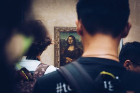A view through the crowd of the Mona Lisa on display.