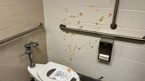 A gender-neutral bathroom finds splatters of canned chili about its walls. This was one of many pranks that took place that night.