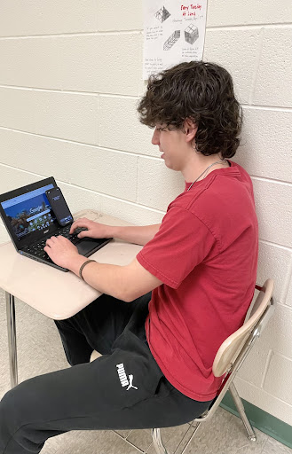 Some students place their phones up against their desk to look at during assessments as demonstrated by a sophomore here.