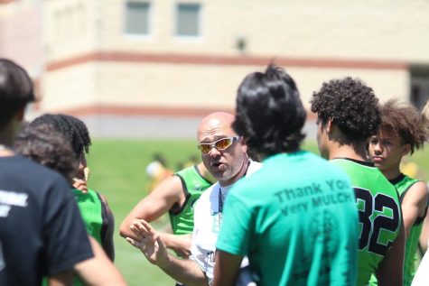 Wildcats 7 vs 7 coach Larry Hurd Jr. provides helpful pointers to his team in the huddle during the Blair 7v7 tournament.