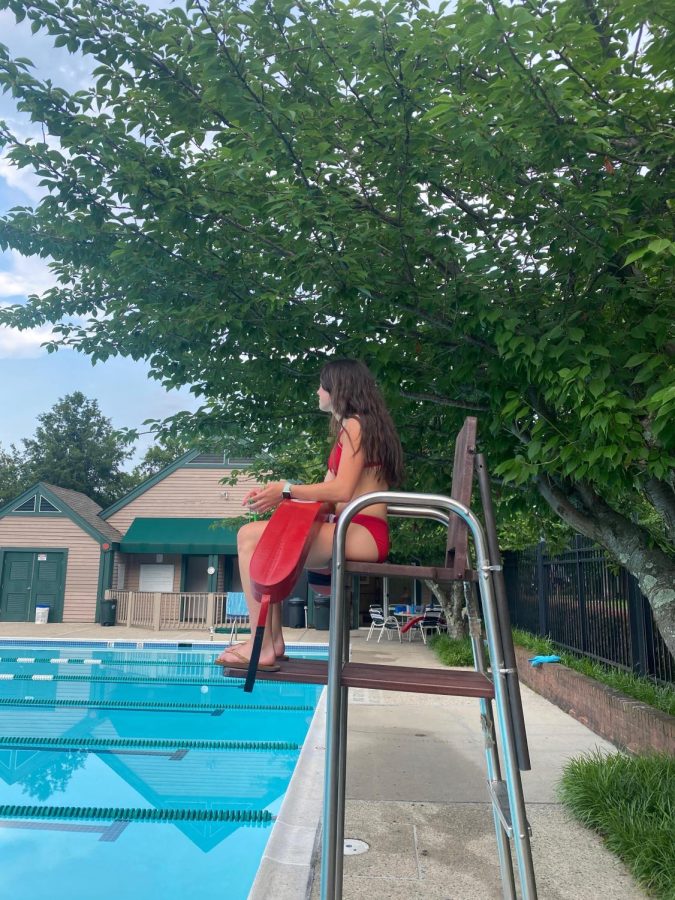 Junior Kate Fuller watches over the pool during her life guarding shift. This is Fullers second summer life guarding and she enjoys the flexible schedule.