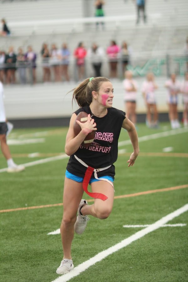 Senior  Eve Forburger runs with the football and tries to get a touchdown. Forburger, representing the senior side in the Powder Puff Games played lacrosse this year as well.