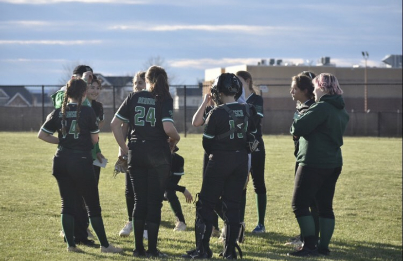 WJs+softball+team+huddle+up+before+game+time.+The+teams+spring+season+ended+abruptly+after+a+loss+to+Whitman.