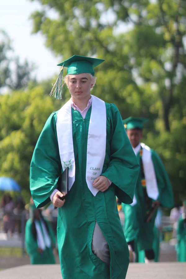 Senior Niko Natsvlishvili walks across the stage after graduating from Walter Johnson.