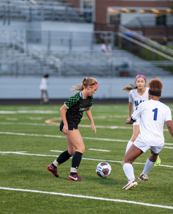 Freshman Evie Avillo takes on two Blair players as she moves down the field with the ball, showing off her great footwork. Avillos love for the game started since she got to dress up as a soccer player in a spirit day at school at a very young age.