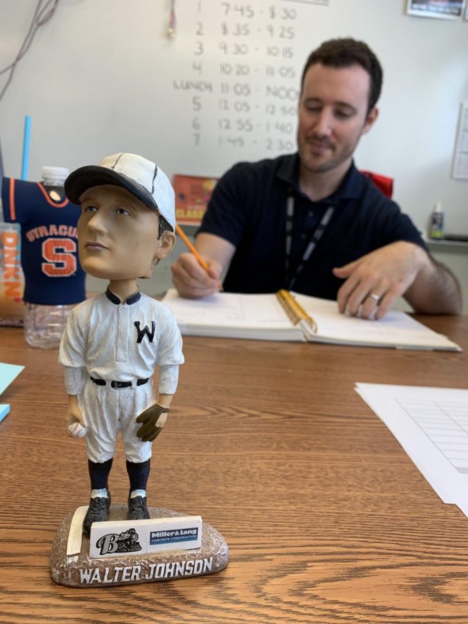 A+bobblehead+version+of+the+famous+Walter+Johnson+nods+at+students+passing+by+English+teacher+and+baseball+fan%2C+Jason+Krakower.+Krakower+was+both+a+baseball+player%2C+as+well+as+an+editorial+producer+for+Major+League+Baseball+Advanced+Media+before+he+joined+WJs+English+department.