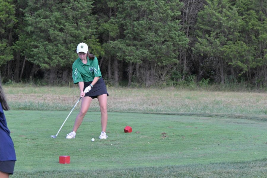 Freshman Elizabeth Martin lines up the shot. She went on to score a 61 in the first match as the Wildcats won by 8 strokes.
