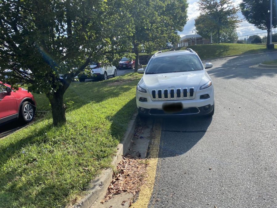 A student arrives too late to get a parking space. This student was forced to park on the side of the road.