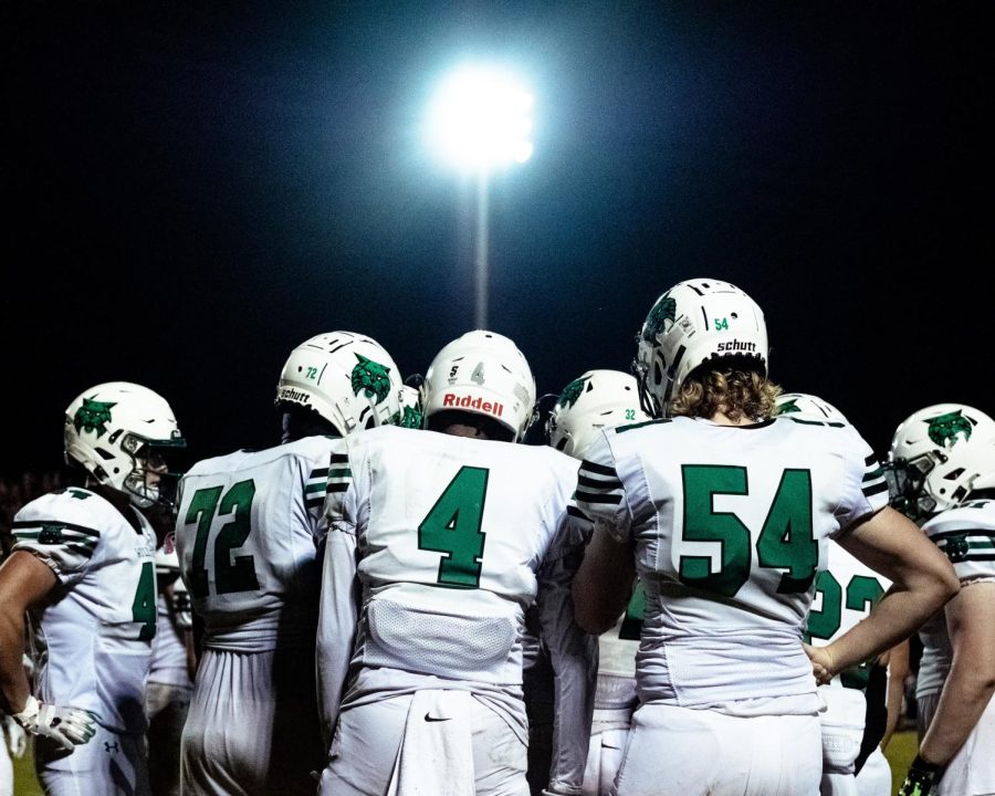 The Wildcats huddle under the lights as they try to fend off the reigning state champions. They were unable to put points on the board as Quince Orchard won 42-0.