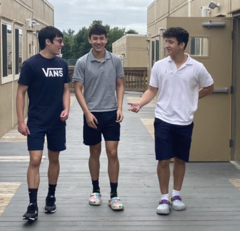 Sophomores Samuel Chang, Charles Ponyicsanyi and Amit Sabba walk through the portables on their way to their US History class. They will have to deal with the locked exterior doors to access their classes in the main building.