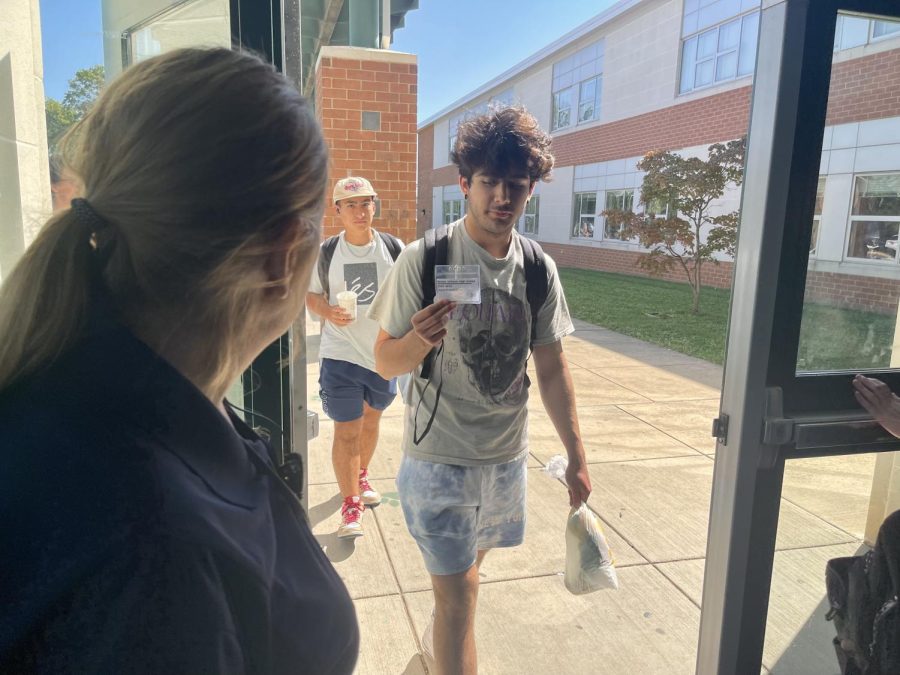 Security guard Kelly McDonnell checks students identification badges as they reenter the building after lunch. The new safety measures implemented this school year require all students and staff to wear an identification at all times in school.