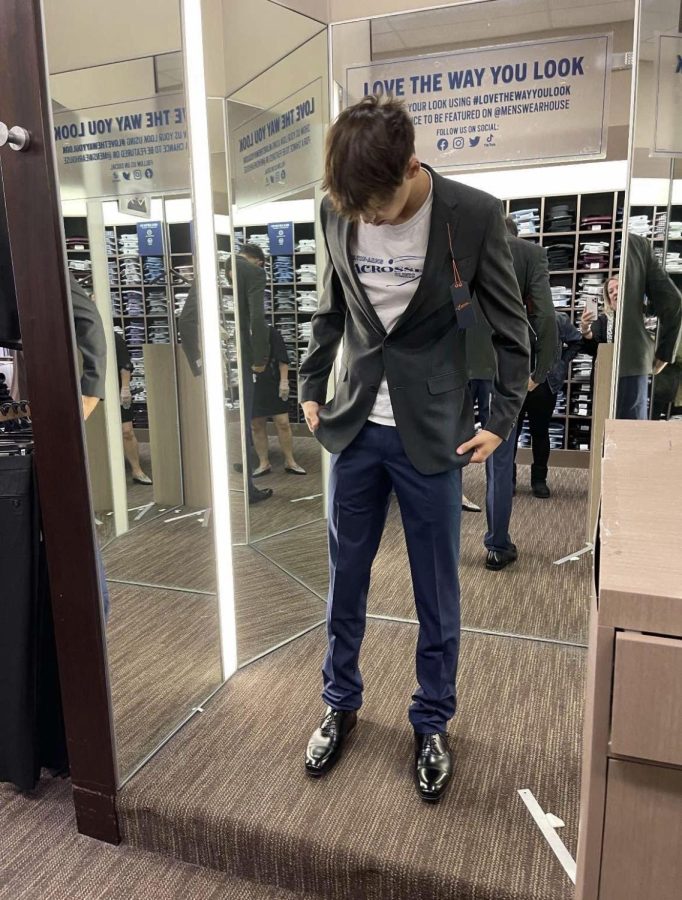 Junior Nick Zayas hops from store to store searching for the perfect suit. Many students start shopping several weeks before Homecoming in order to be put together ahead of time.