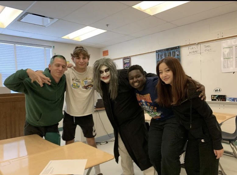 (From left) SGA Vice President Luke Liden, President Ethan Mendes, social studies teacher Fred Dellelo, Secretary Bryan Kibet and Treasurer Lauren Kim pose for behind-the-scenes photos of the Homecoming movie.