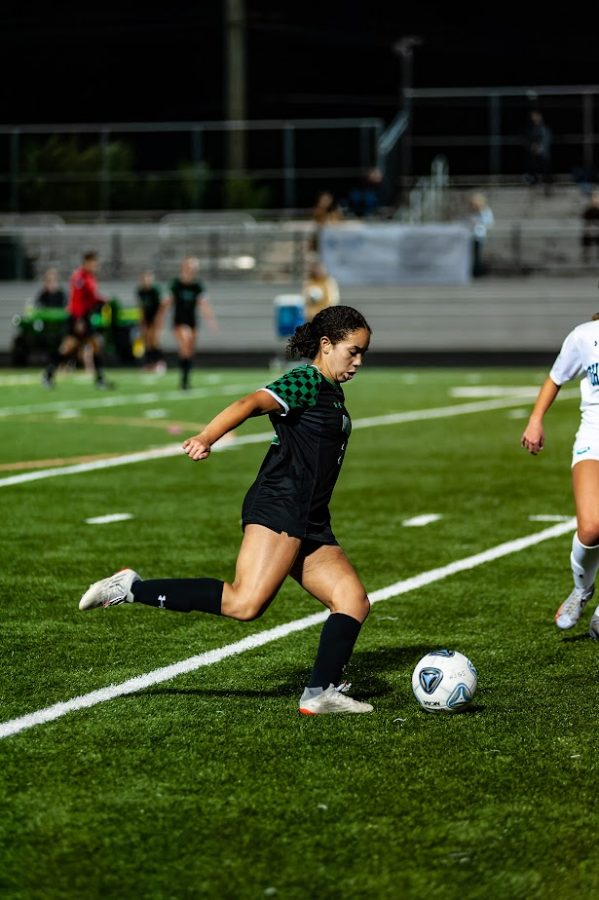 Senior midfielder Julia Lebron-Echandy moves the ball down the field during the Cats 3-1 win over Churchill. The Wildcats have won all but one of their games and will have a bye during the playoffs.
